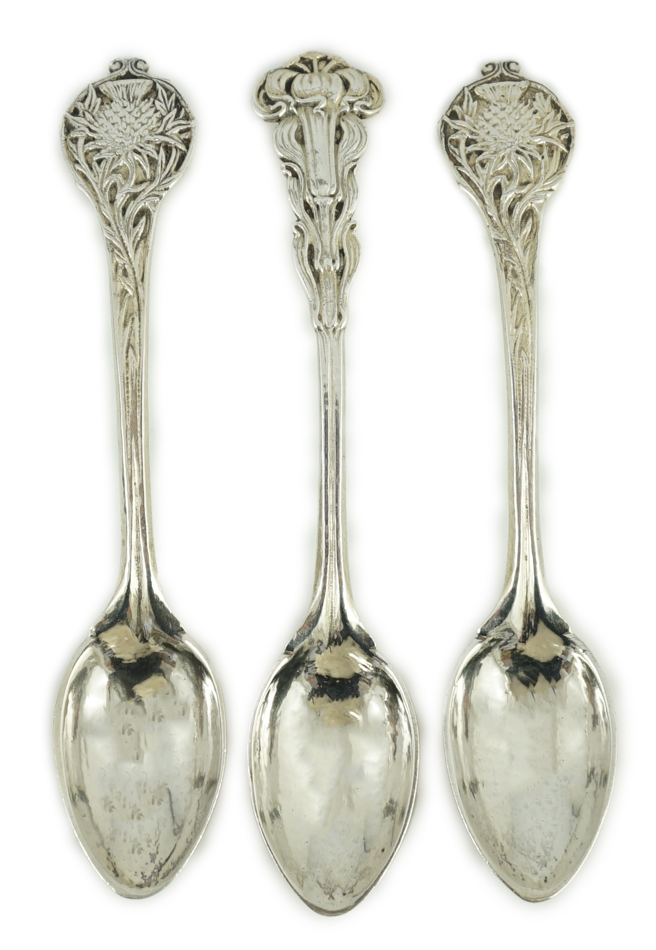 A cased set of three George V Arts & Crafts planished silver spoons by Omar Ramsden